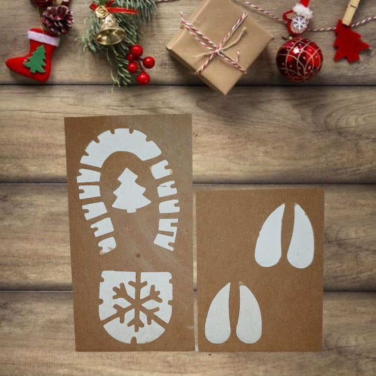 Stencil navideño con huellas de Santa Claus y reno sobre superficie blanca